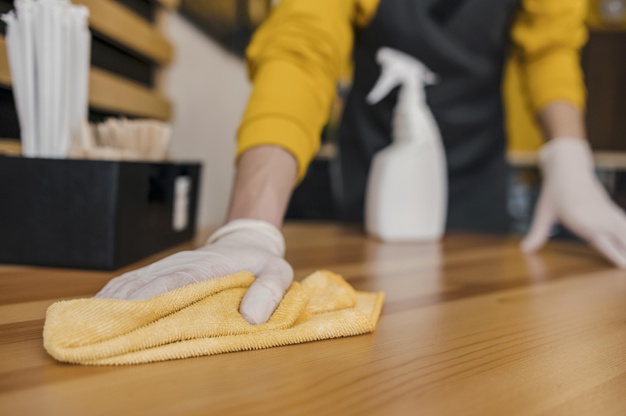 lady cleaning floor with mop by hand